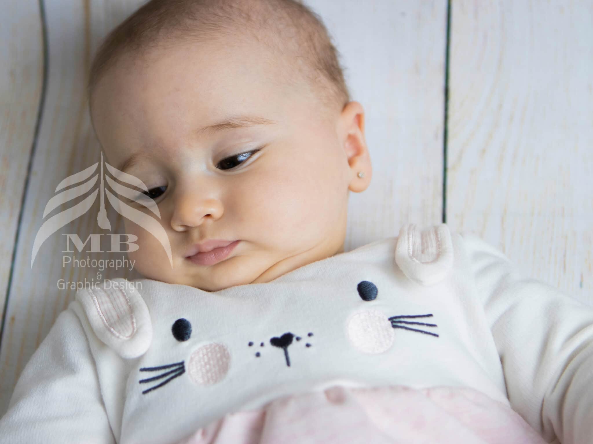 Photography Portfolio 36 Mariam Cheaitou Bazzi Photography Portfolio in Windsor Close-up portrait of a baby girl wearing a soft white and pink bunny outfit during a milestone photography session in Windsor, Ontario.