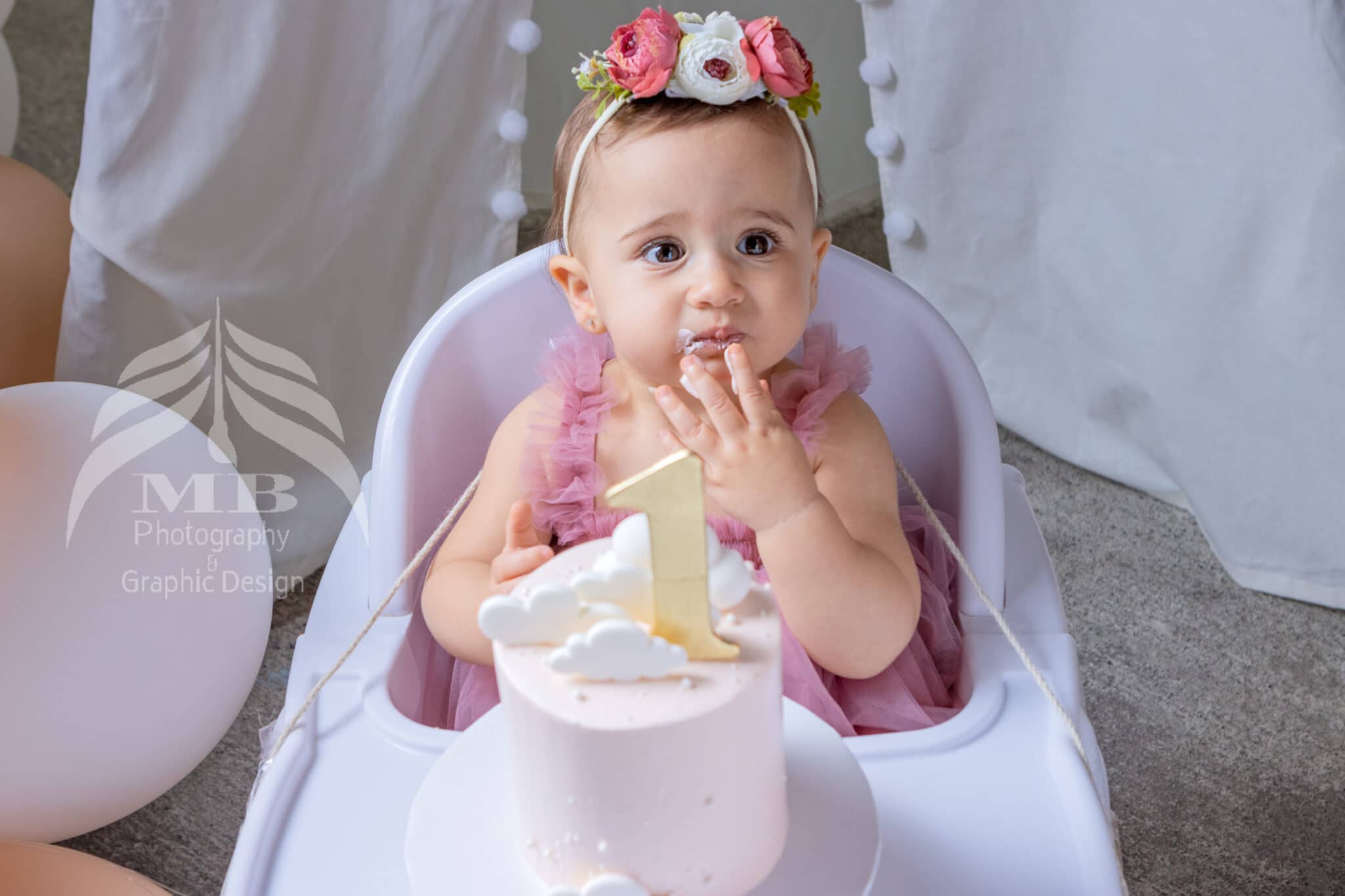 Photography Portfolio 46 Mariam Cheaitou Bazzi Photography Portfolio in Windsor One year old girl eating birthday cake frosting during cake smash session, professional first birthday photography by Windsor Ontario photographer