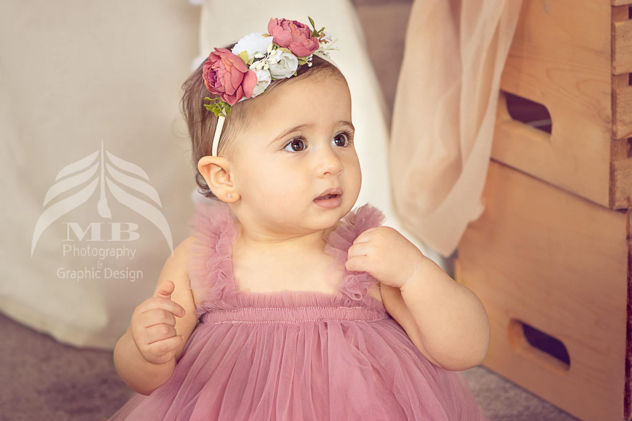 Photography Portfolio 42 Mariam Cheaitou Bazzi Photography Portfolio in Windsor Close-up of one year old girl in pink tulle dress with floral crown looking to the side, milestone photography by Windsor Ontario photographer