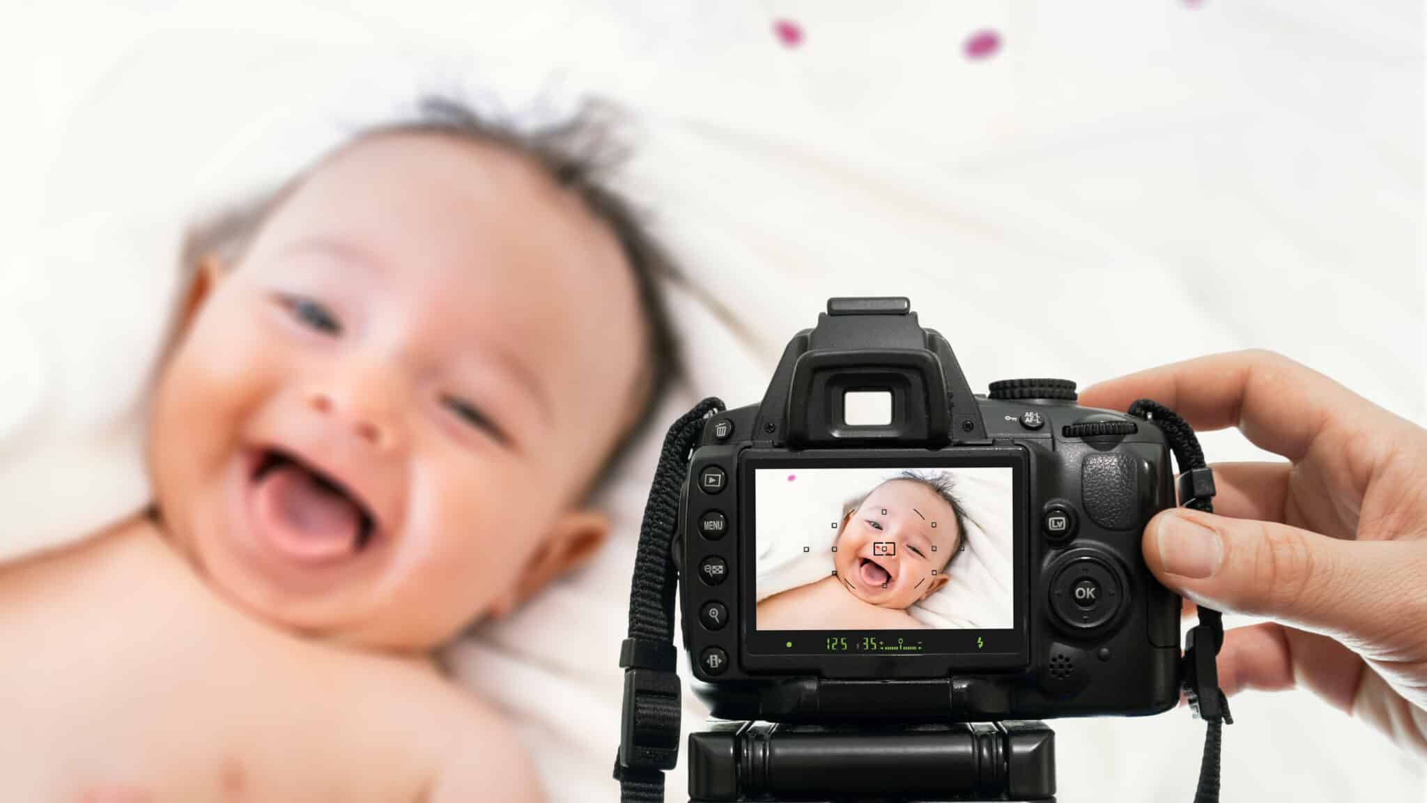 Camera screen displaying photo of laughing baby during session, behind the scenes with Windsor Ontario baby photographer