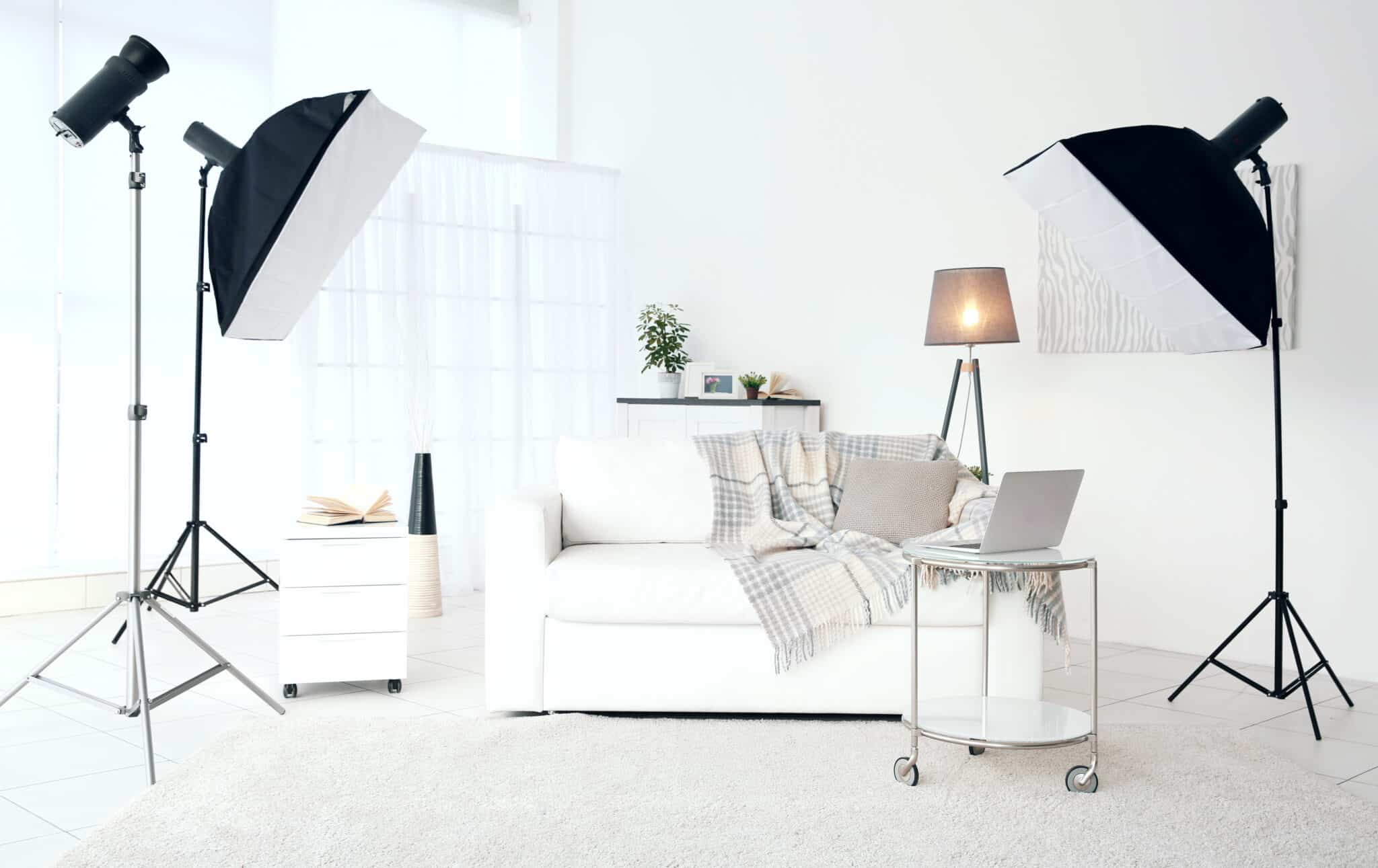 Photography studio lighting setup with softboxes in a bright white living room