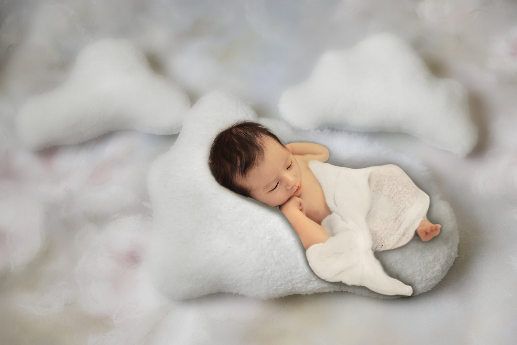 Photography Portfolio 24 Mariam Cheaitou Bazzi Photography Portfolio in Windsor Newborn baby sleeping on cloud-shaped digital composite background, creative newborn photography by Windsor Ontario photographer