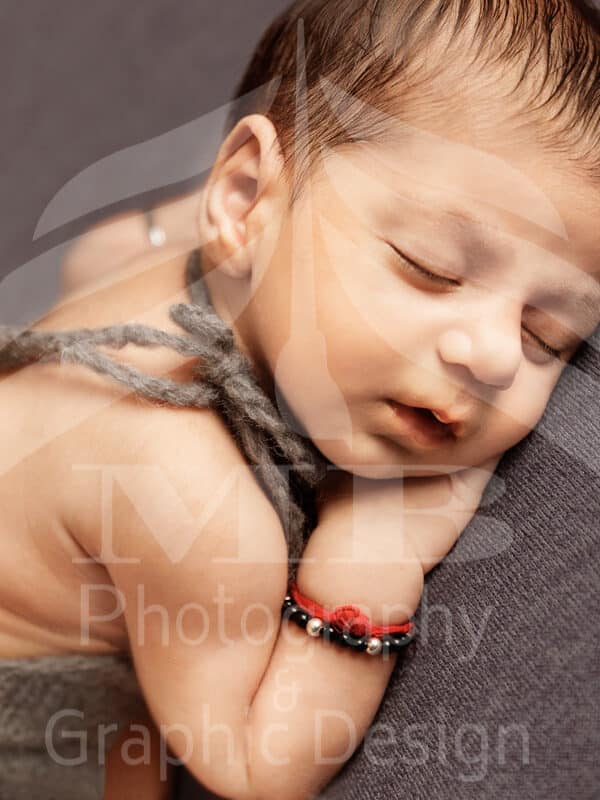 Photography Portfolio 18 Mariam Cheaitou Bazzi Photography Portfolio in Windsor Close-up of sleeping newborn baby resting on hand, professional newborn photography by Windsor Ontario photographer