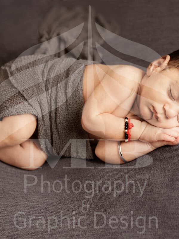 Photography Portfolio 21 Mariam Cheaitou Bazzi Photography Portfolio in Windsor Newborn baby sleeping with hands folded under chin, professional newborn photography by Windsor Ontario photographer